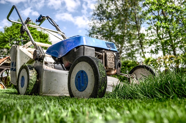 A Lawnmower on a lawn mowing grass on someones yard