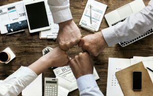 People working together at a credit union. Credit unions are great for member service. Many people prefer to work with a credit union over working with a bank.
