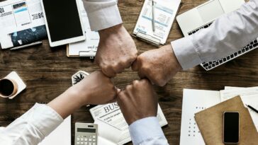 People working together at a credit union. Credit unions are great for member service. Many people prefer to work with a credit union over working with a bank.